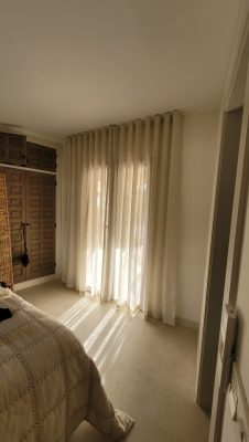 perfect wave linen curtains hanging in bedroom
